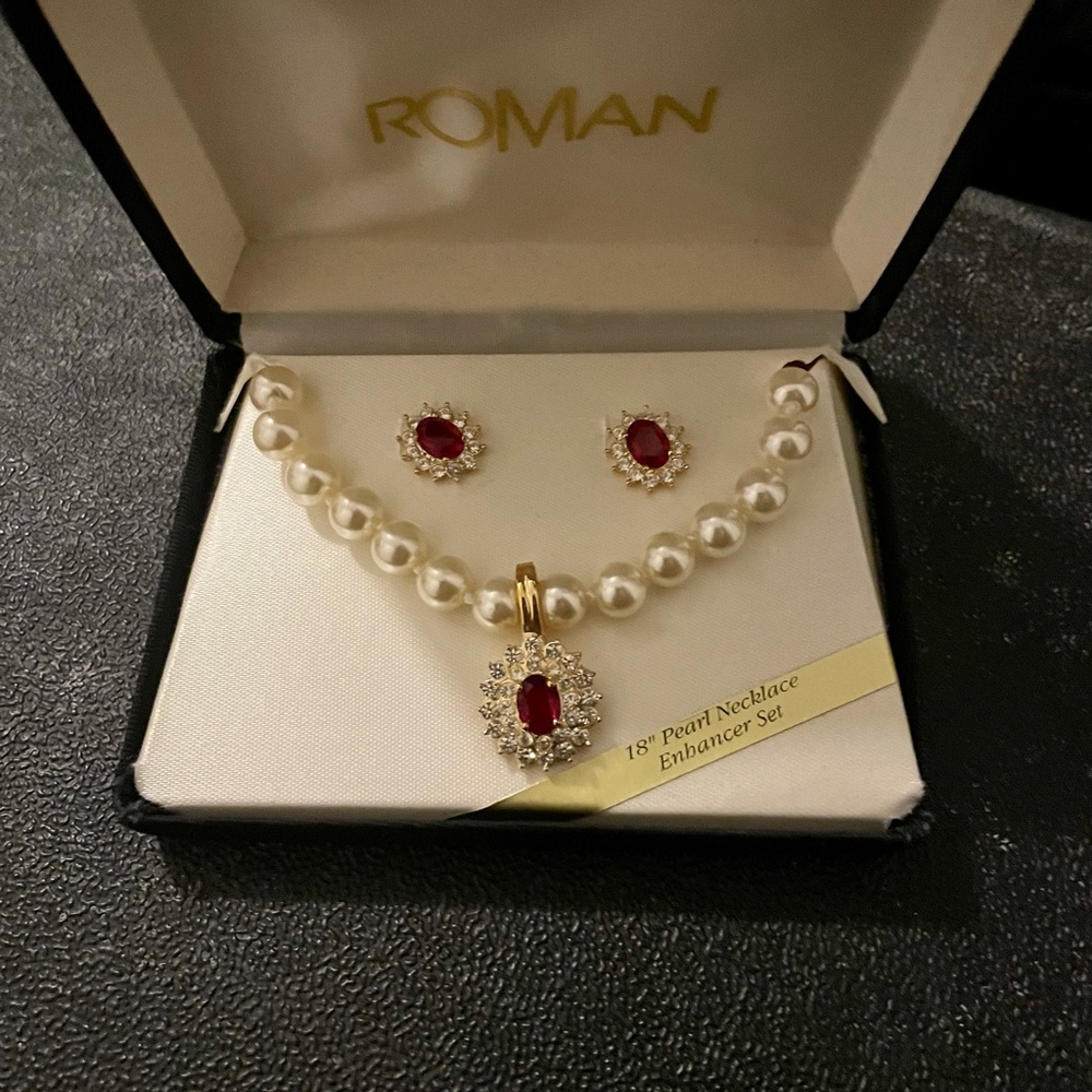 18 inch pearl enhancer necklace with matching earrings. The stone is red Rubys.